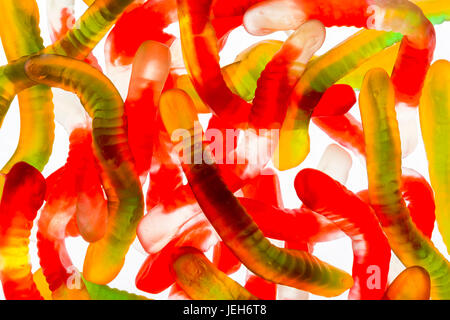 Colourful candied gummy worms backlit; Calgary, Alberta, Canada Stock Photo
