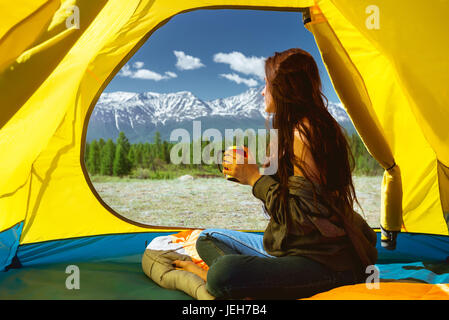 Young woman cup mountains tent Stock Photo