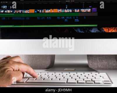 Man working on modern computer video editing desk setup Stock Photo