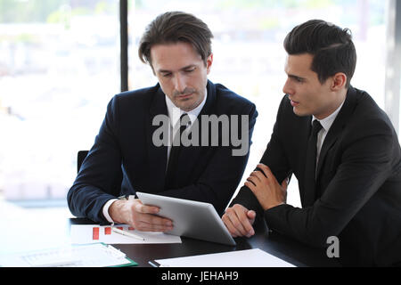 Business people using tablet pc together at office Stock Photo