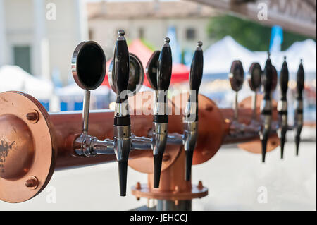 Drought beer taps and other beverages in a bar. Stock Photo