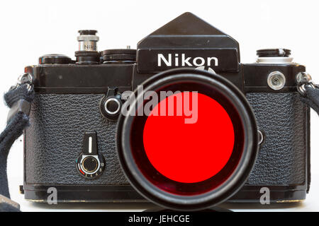 a Nikon F2 camera with a red filter on a 135mm lens. As used in the 1970's. Stock Photo