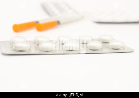 Contraceptive tablets in packages and without on a light background. Stock Photo