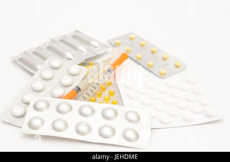 Contraceptive tablets in packages and without on a light background. Stock Photo