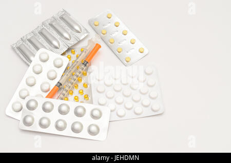 Contraceptive tablets in packages and without on a light background.