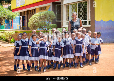 Portrait of a teacher with her early education students at Treasures Christian Preschool; Kampala, Uganda Stock Photo
