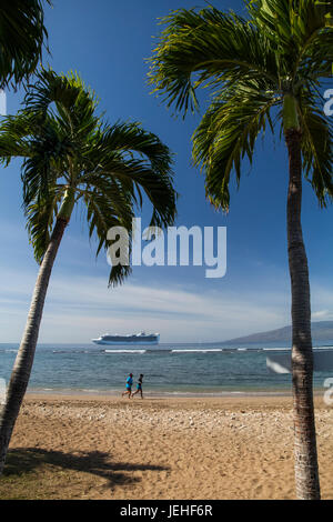 Joggers on beach, cruise ship off of Puamana Beach just south of Lahaina town; Lahaina, Maui, Hawaii, United States of America Stock Photo