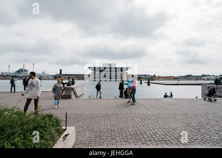 Copenhagen, Denmark - August 12, 2016: Tourists in Amaliehaven waterfront with Opera House building on background in Copenhagen a cloudy day of summer Stock Photo