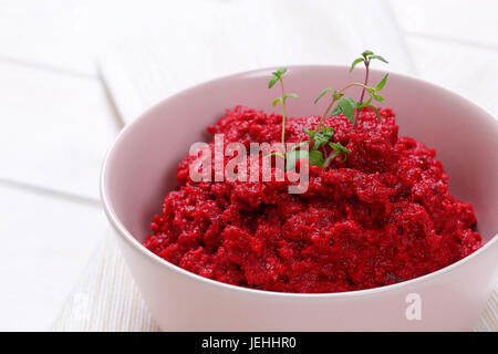 bowl of fresh beetroot puree on white place mat - close up Stock Photo