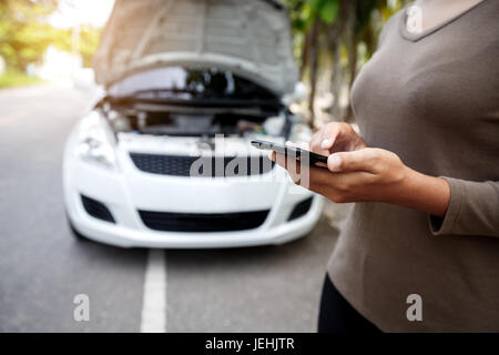 close-up on woman hand using phone call emergency car service Stock Photo