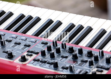 electronic synthesizer with keys, midi controller volume fader, knobs and sliders Stock Photo