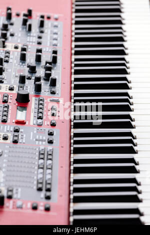 professional midi keyboard synthesizer with knobs and sliders. side view. Stock Photo