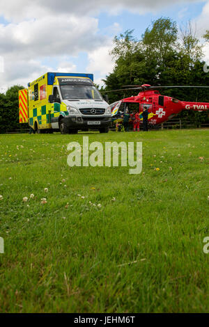 The Thames Valley Air Ambulance lands in an Oxfordshire field prior to transport a seriously ill casualty to hospital. Stock Photo