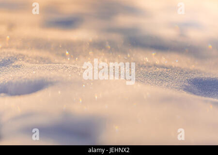 Shiny snow in sunlight. Calm seasonal photo, winter closeup background with blurred background Stock Photo