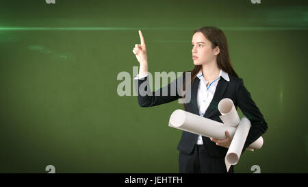 Building, developing, consrtuction and architecture concept -professional beautiful businesswoman in suit with blueprint Stock Photo