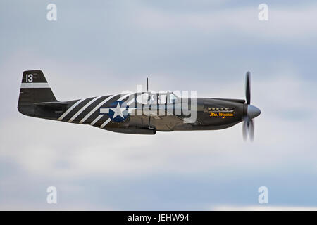 Airplane WWII P-51 Mustang fighter flying at air show Stock Photo