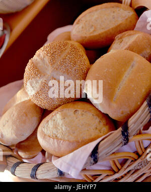 Beautiful composition with bread and buns in wicker basket Stock Photo