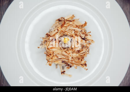 Salad in the form of a nest and decorated with quail eggs. Stock Photo