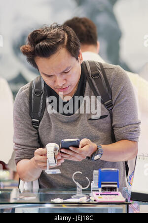 SEOUL-OCT. 24, 2015. Korean man in tax free shop on Incheon International Airport. With 90 duty free shops it is Shopaholics Heaven. Basically it is a Stock Photo