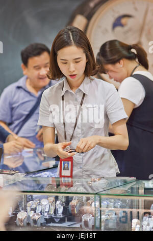 SEOUL-OCT. 24, 2015. Saleswoman in a tax free shop on Incheon International Airport. With 90 duty free shops it is Shopping Heaven. Stock Photo