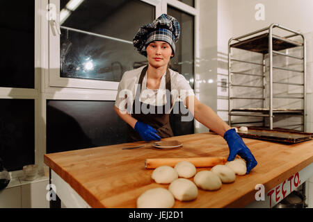 a Baker making cinnamon rolls Stock Photo