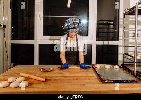a Baker making cinnamon rolls Stock Photo
