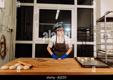 a Baker making cinnamon rolls Stock Photo