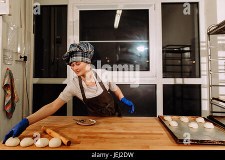 a Baker making cinnamon rolls Stock Photo