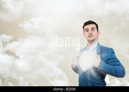 Young businessman acting with courage like a super hero and tearing his shirt off. Proud of yourself emotion isolated on white background.Belive in yo Stock Photo