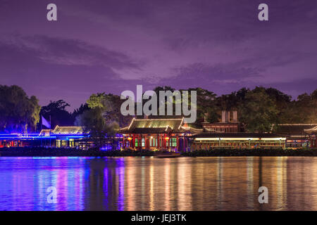Houhai area at twilight with neon lights reflected in the lake, Beijing, China Stock Photo