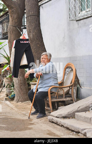 BEIJING-SEPT. 28, 2007. Elderly inhabitant of Beijing hutong. Hutongs are narrow ancient alleys, concentrated around Forbidden City. Stock Photo
