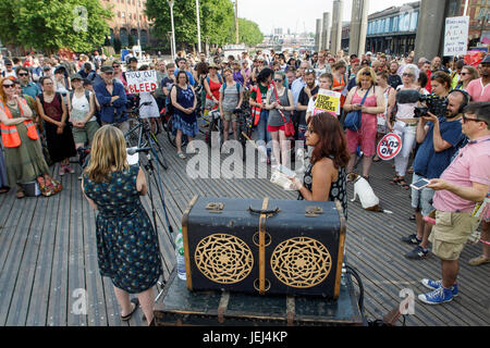 Protesters carrying placards are pictured listening to speeches before taking part in a Austerity kills,Justice for Grenfell protest march in Brisol. Stock Photo