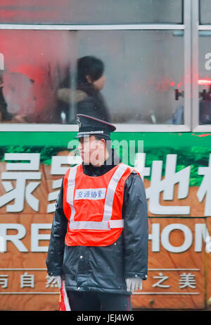HEFEI-CHINA-JAN. 6, 2009. Distressed policeman on an early rainy morning. Unlike US or Hong Kong police, most policemen in China don not carry guns. Stock Photo