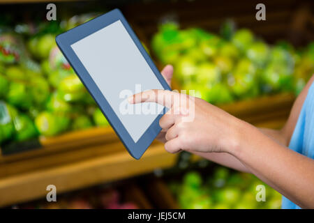 Womans hand using tablet Stock Photo