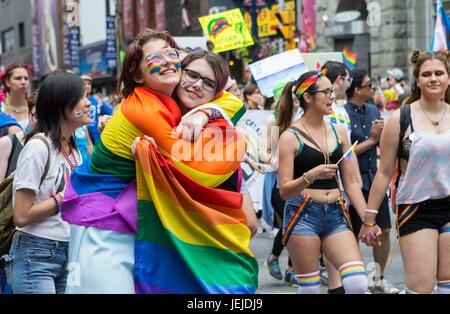 Toronto, Canada. 25th June, 2017. Two women hug during the 2017 Pride Parade in Toronto, Canada, June 25, 2017. Credit: Zou Zheng/Xinhua/Alamy Live News Stock Photo