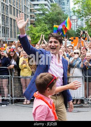 Toronto, Canada. 25th June, 2017. Canadian Prime Minister Justin Trudeau (C) waves to people during the 2017 Pride Parade in Toronto, Canada, June 25, 2017. Credit: Zou Zheng/Xinhua/Alamy Live News Stock Photo