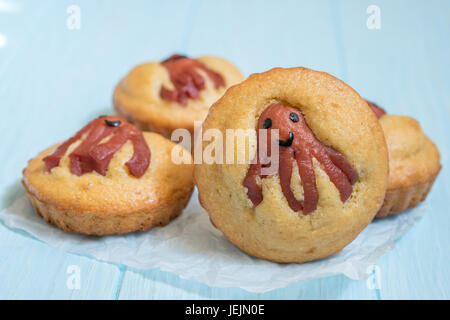 Kid funny food. Cornbread corn dogs muffins with cute octopus sausage snack Stock Photo