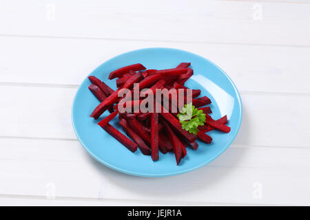 plate of beetroot strips on white wooden background Stock Photo