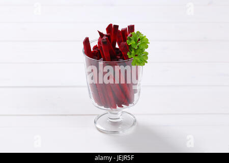 glass of beetroot strips on white wooden background Stock Photo
