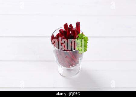 glass of beetroot strips on white wooden background Stock Photo