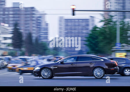 BEIJING-MAY 23. Jaguar XJ limousine in city center at twilight. Jaguar achieved its best ever global sales, with up 30% market performance. Stock Photo