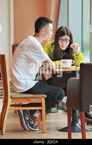 BEIJING-AUGUST 19, 2015. Young couple at Costa café. Costa owner Whitbread, which operate through two joint ventures in China. Stock Photo