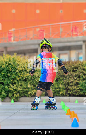 BEIJING-JULY 10, 2015. Boy practicing inline skating. Although Ping-Pong, basketball, badminton are China’s top sports, skating became very popular! Stock Photo
