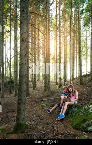 Boy and girl using digital tablet in forest Stock Photo