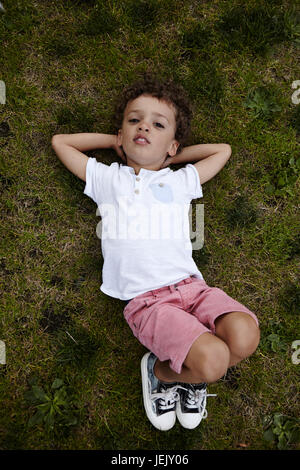 Boy lying on grass Stock Photo