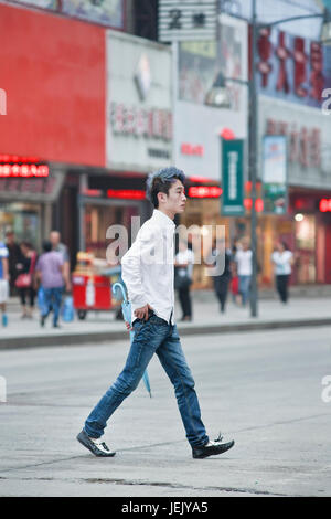 CHANGCHUN-CHINA-JULY 8. Fashionable guy in city center. Because of prosperity and westernization, fashion is on the minds of China's youngsters. Stock Photo