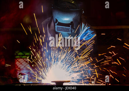 Industrial workers are welding assembly automotive part in car factory Stock Photo