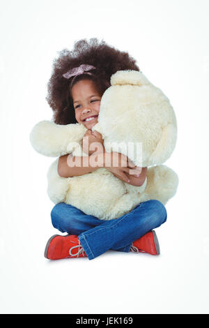 Girl sitting on the floor, hugging her teddy bear, Sweden Stock Photo ...