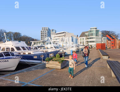 TURNHOUT-APRIL 8, 2017. Woman with children walking along a quay with moored yachts at Nieuwe Kaai, on Kempisch Canal. Stock Photo