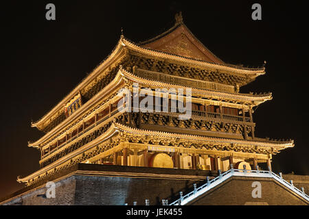 The illuminated ancient Drum Tower located at the ancient city wall by night time, Xian, Shanxi Province, China Stock Photo